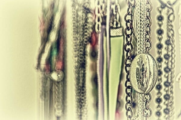 Close-up of necklaces hanging on a wall