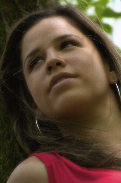 Portrait of Kathy leaning against a tree